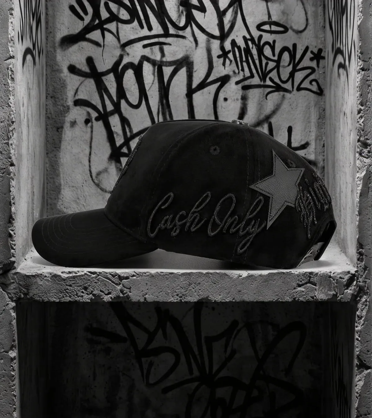 Gorra Cash Only sobre pared de grafiti, vista lateral